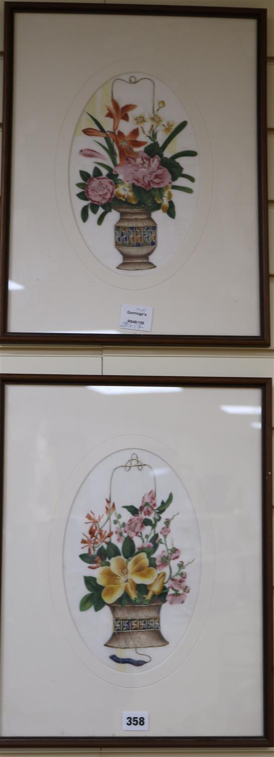 A pair of 19th century Chinese pith paper paintings, depicting baskets of flowers, framed to the oval, 28 x 17cm